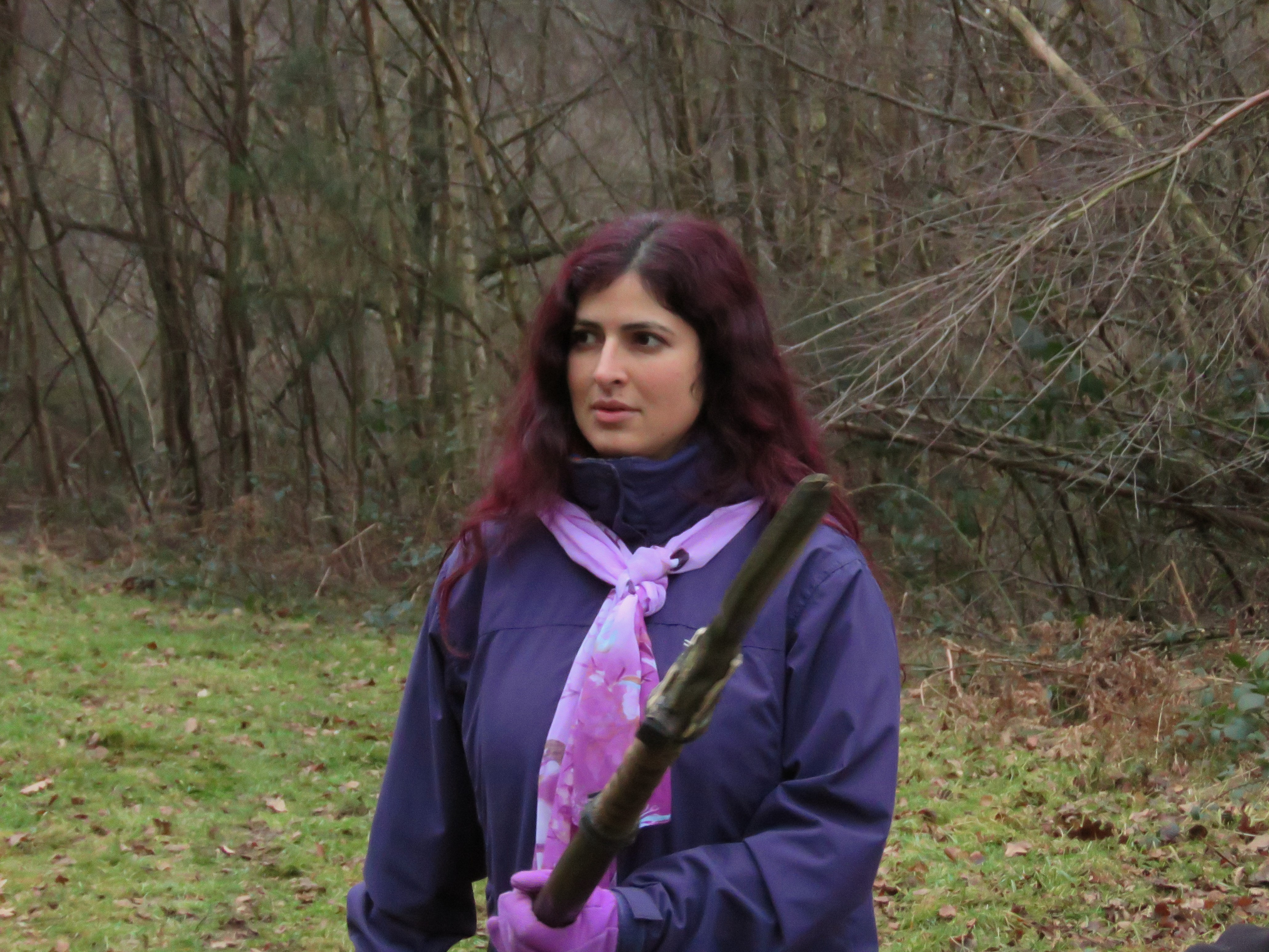  a player in purple, venturing forward apprehensively, weapon ready, but also seeming intrigued